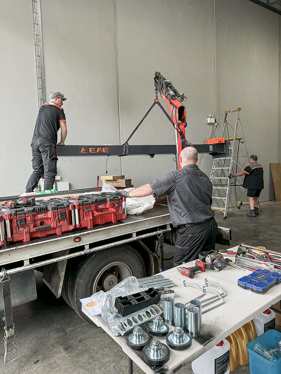 People helping set up workshop equipment.