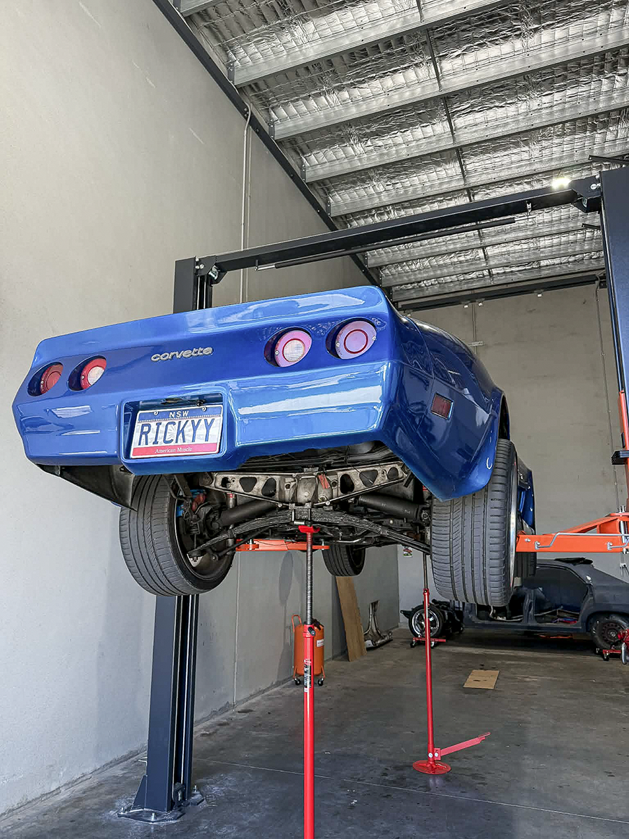 A Corvette raised in the workshop bay.