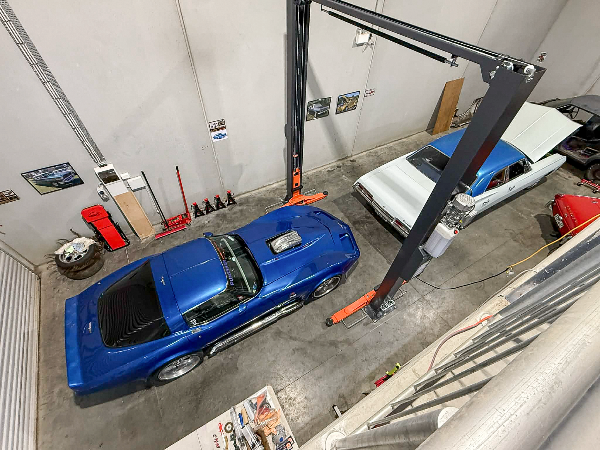 Overhead view of the Mittagong workshop showing the vehicle hoist, classic cars and working space